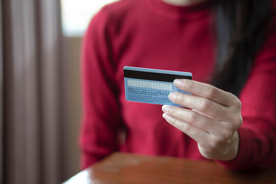 Close up woman hands holding credit card, using banking service, online shopping.