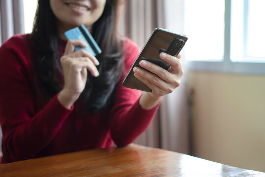 Close up woman hands holding mobile smart phone and credit card, using banking service, online shopping.
