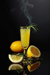 Traditional homemade lemon liqueur limoncello on the black background.