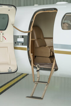 Stairs and door of a small private jet in hangar ready to fly- stock photo