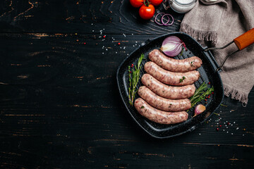 Raw stuffed sausages on srill pan with spices and rosemary on cutting board. Cooking ingredients....
