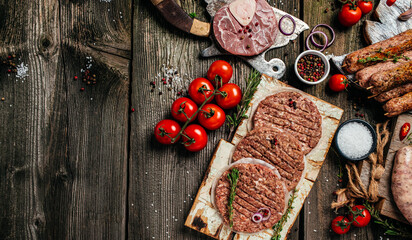 Raw meat products, different parts of the body. minced beef meat kebabs, pork, beef, chicken on a wooden background. banner, menu, recipe place for text, top view