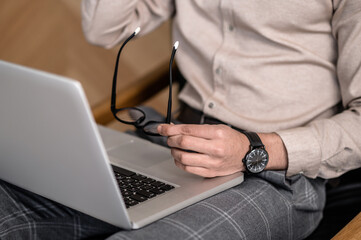 A close up picture of a man with a laptop