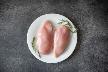 Raw chicken fillet on stone background