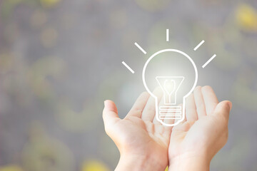 two hand of young business man open with blub  light of idea, sketch light bulb on blur background