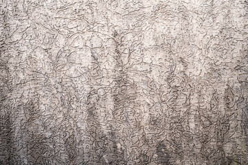 Gray textured background, with sinuous prints. Copy space. 