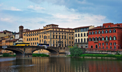 Colorful Quarter of Florence. The bridge over the river Arno leads to a colorful multi-colored quarter. Houses painted in different colors are reflected in the water. April 28, 2011. Italy, Florence, 