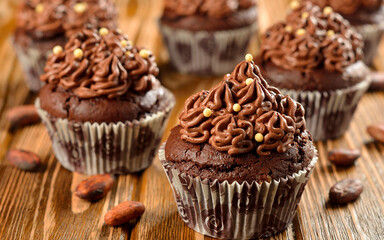 Delicious chocolate muffins on wodd table