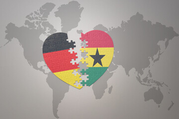 puzzle heart with the national flag of ghana and germany on a world map background. Concept.