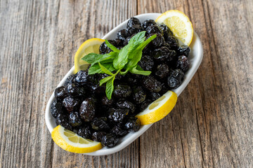 Black olive. Natural black olive on wood floor background. Healthy food. close up