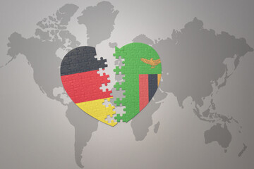 puzzle heart with the national flag of zambia and germany on a world map background. Concept.