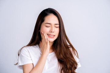 Beautiful Asian woman has a toothache isolated on white background.