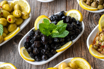 Olives. Varieties of olives on wood background. Healthy food. Selective focus olive. close up