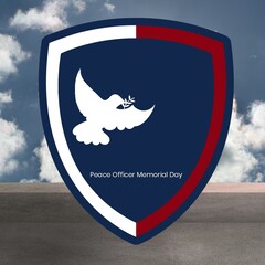 Peace officer memorial day with white dove on blue shield against sky