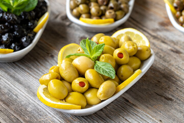 Olives. Varieties of olives on wood background. Healthy food. Selective focus olive. close up