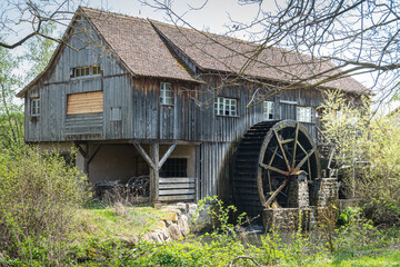 Traditional old alsatian water mill in the Ecomuseum Alsace in city of Mulhouse, Alsace, France