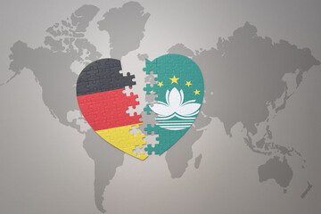 puzzle heart with the national flag of Macau and germany on a world map background. Concept.