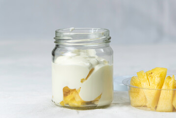 fresh natural homemade organic yogurt in glass bottle on white table.