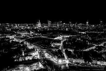 Black and white Aerial view of old buildings, castles and a church in the old city of Warsaw. Cityscape of old buildings and architecture in the old town in Warsaw. Night time