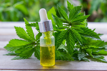 hemp oil. fresh cannabis leaves. Jars of cannabis oil.