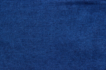 Texture of blue denim close-up. Modern high-quality material for clothes.