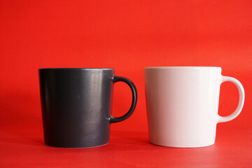 cup of coffee with beans on red background