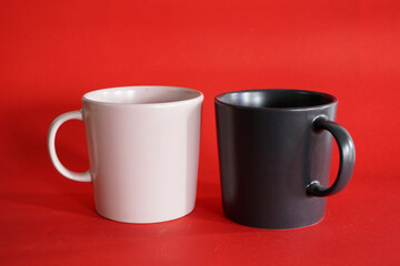 cup of coffee with beans on red background