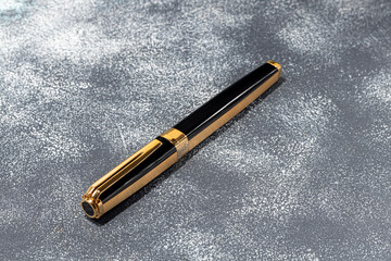 Fountain pen on a marble and gray background. Selective focus.