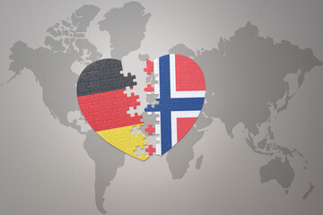 puzzle heart with the national flag of norway and germany on a world map background. Concept.