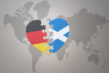 Fototapeta premium puzzle heart with the national flag of scotland and germany on a world map background. Concept.