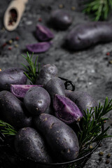 Obraz na płótnie Canvas Raw sweet potatoes on dark background closeup. Batata potato. vegan food ingredient. vertical image. top view. place for text