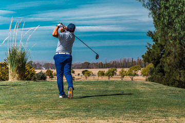 golfer shooting a golf ball