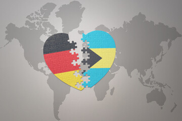 puzzle heart with the national flag of bahamas and germany on a world map background. Concept.