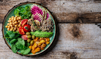 Buddha Bowl with Quinoa, Avocado, mushrooms, cucumber, chickpeas, spinach, tomatoes, vegetables salad. Clean eating, dieting, vegan food concept. top view