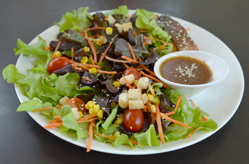 fresh salad with bread on white dish