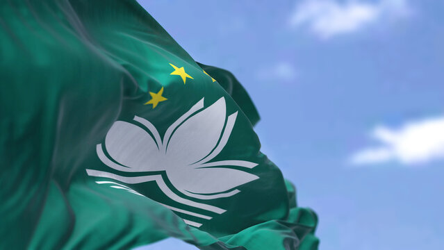 The flag of Macau waving in the wind on a clear day