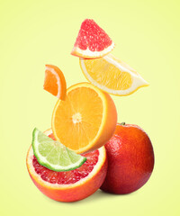 Fresh juicy citrus fruits on beige background