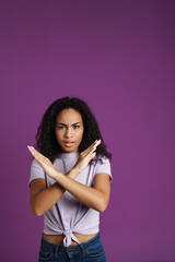 Young black woman frowning while showing stop gesture