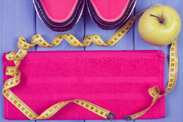 Sport shoes, accessories for fitness and fresh apple. Healthy sporty lifestyles
