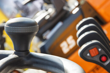 Steering wheel and operating control panels or levers with buttons in forklift or other industrial machine