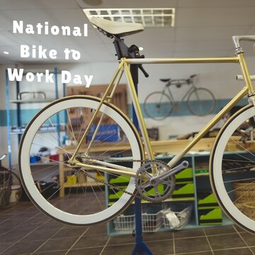 Composite image of national bike to work day text with bicycles in workshop