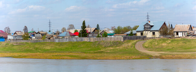 View across the river to the outskirts of the urban-type settlement of Yaya