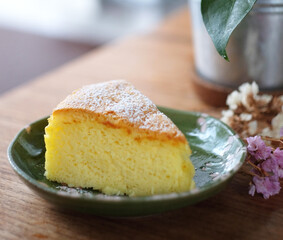 Japanese cotton cheesecake on wood table with powdered sugar on top. Selective focus