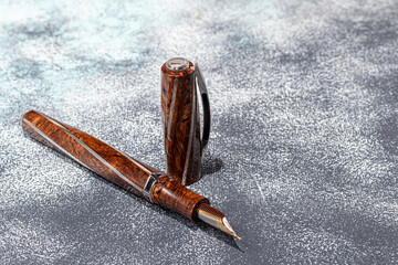 Fountain pen on a marble and gray background. Selective focus.