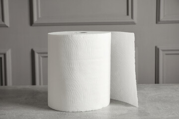 Roll of white paper towels on grey table