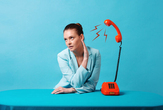  Woman talking over the phone over a blue background, concept