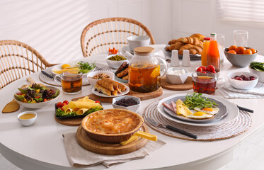 Many different dishes served on buffet table for brunch