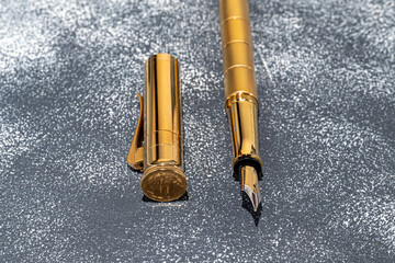 Fountain pen on a marble and gray background. Selective focus.