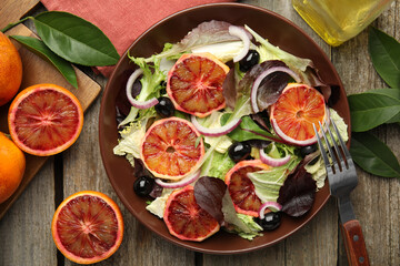 Delicious sicilian orange salad served on wooden table, flat lay