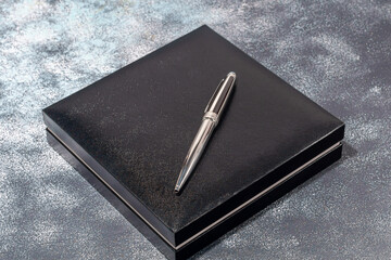 Fountain pen on a marble and gray background. Selective focus.